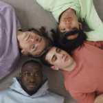 Group of men gathered together, symbolizing discussions about masculinity, belonging, and emotional well-being.